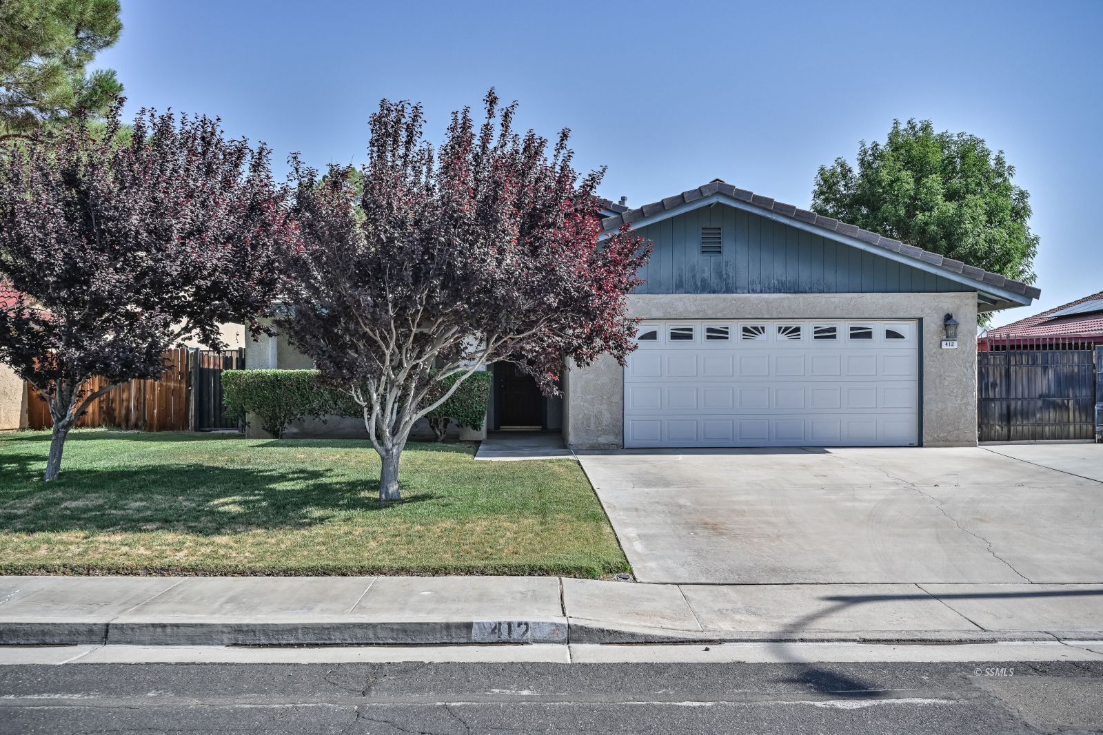 412 Lorene Court Ridgecrest, CA 93555 - Photo 1 of 31 a front view of a house with a yard and garage