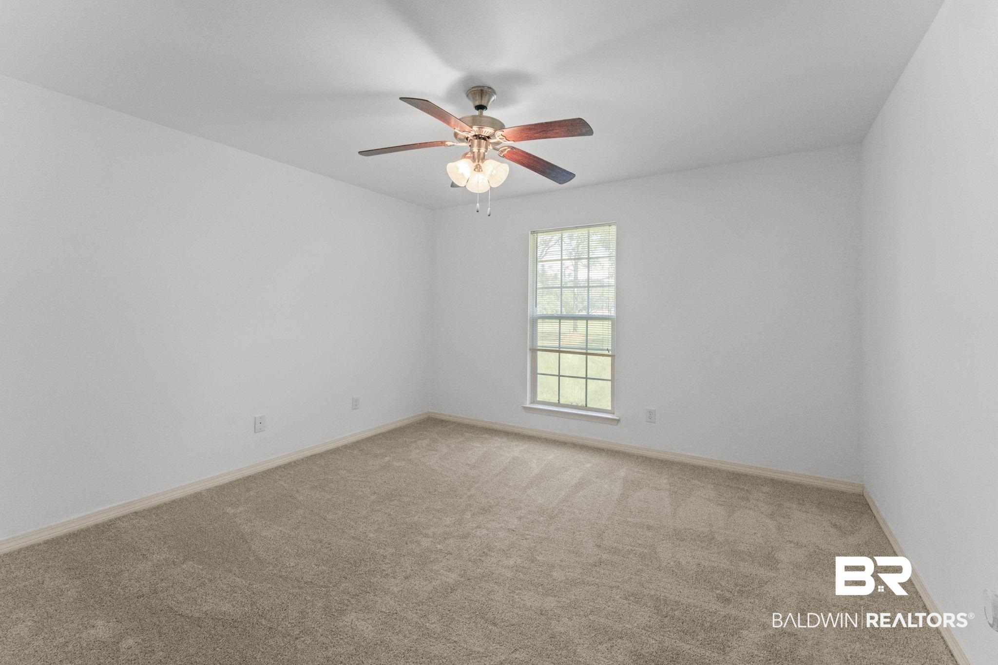 10535 Rhett McConnell Road Theodore, AL 36582 - Photo 24 of 36 Spare room featuring light colored carpet and ceiling fan