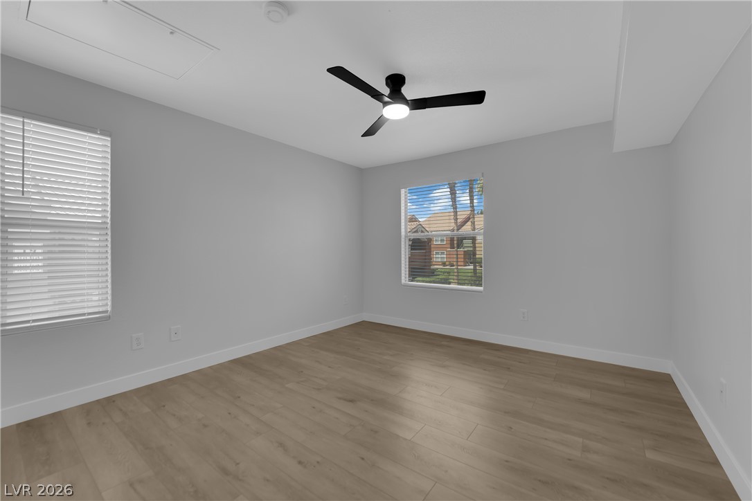 8101 West Flamingo Road, Unit 2152 Las Vegas, NV 89147 - Photo 14 of 45 Laminate flooring and a ceiling fan create a comfortable and inviting atmosphere in this well-lit space.