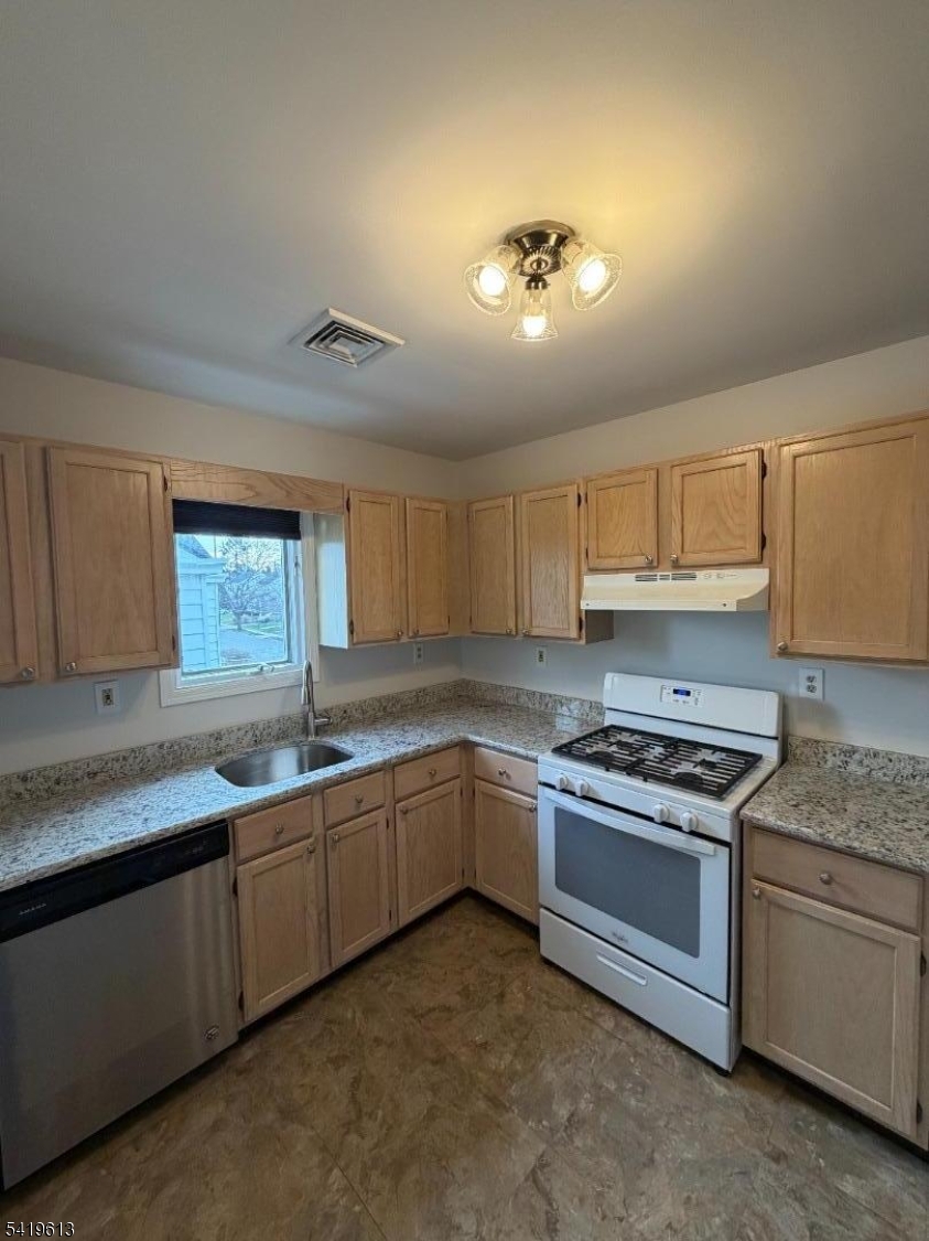 101 Liberty Street, Unit 2 Bloomfield, NJ 07003 - Photo 6 of 11 a kitchen with stainless steel appliances granite countertop a sink stove and cabinets