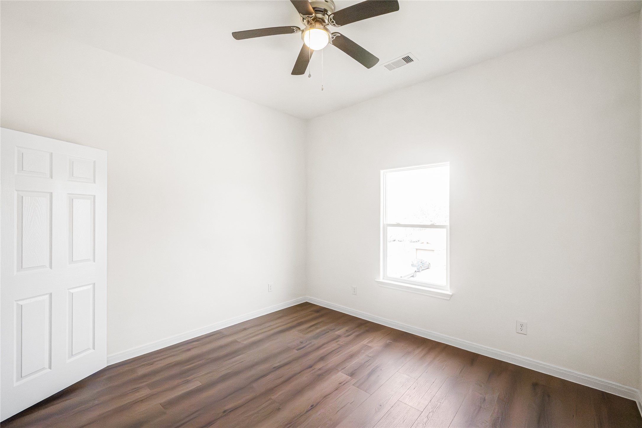 6413 North Ridgecrest Drive Hitchcock, TX 77563 - Photo 26 of 29 an empty room with wooden floor ceiling fan and windows