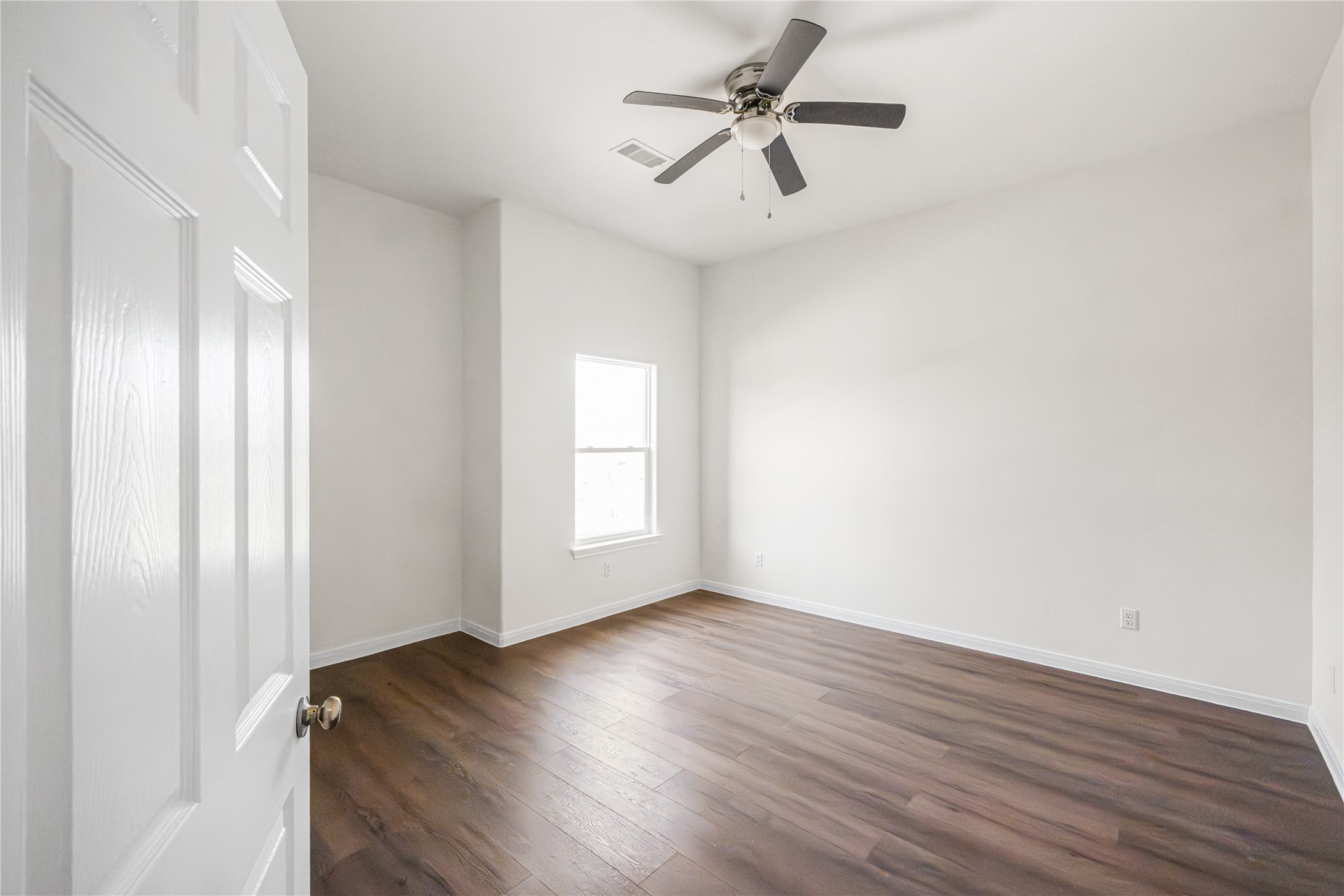 6413 North Ridgecrest Drive Hitchcock, TX 77563 - Photo 29 of 29 an empty room with wooden floor fan and windows