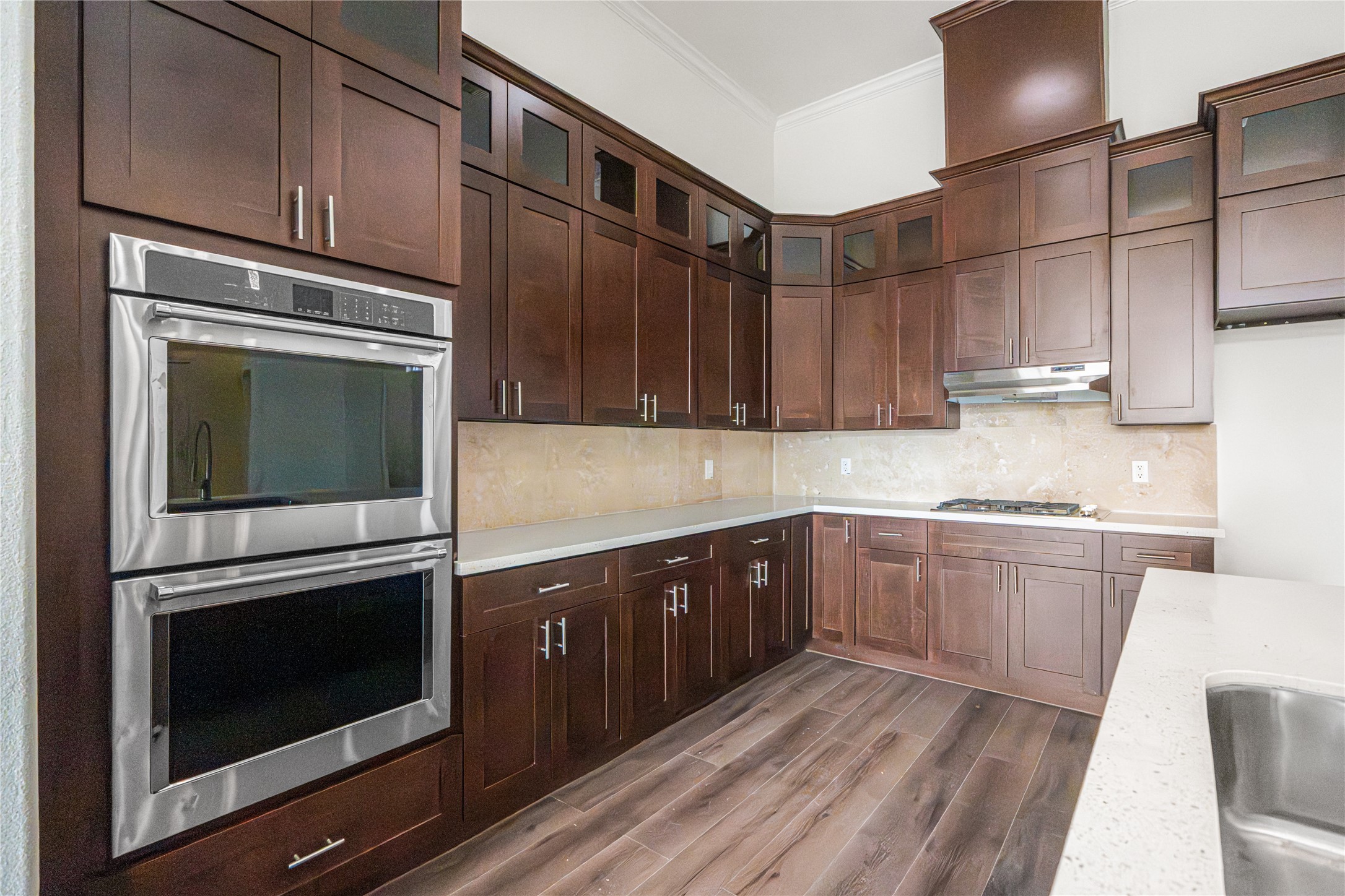 6413 North Ridgecrest Drive Hitchcock, TX 77563 - Photo 10 of 29 a kitchen with granite countertop wooden cabinets stainless steel appliances and counter space