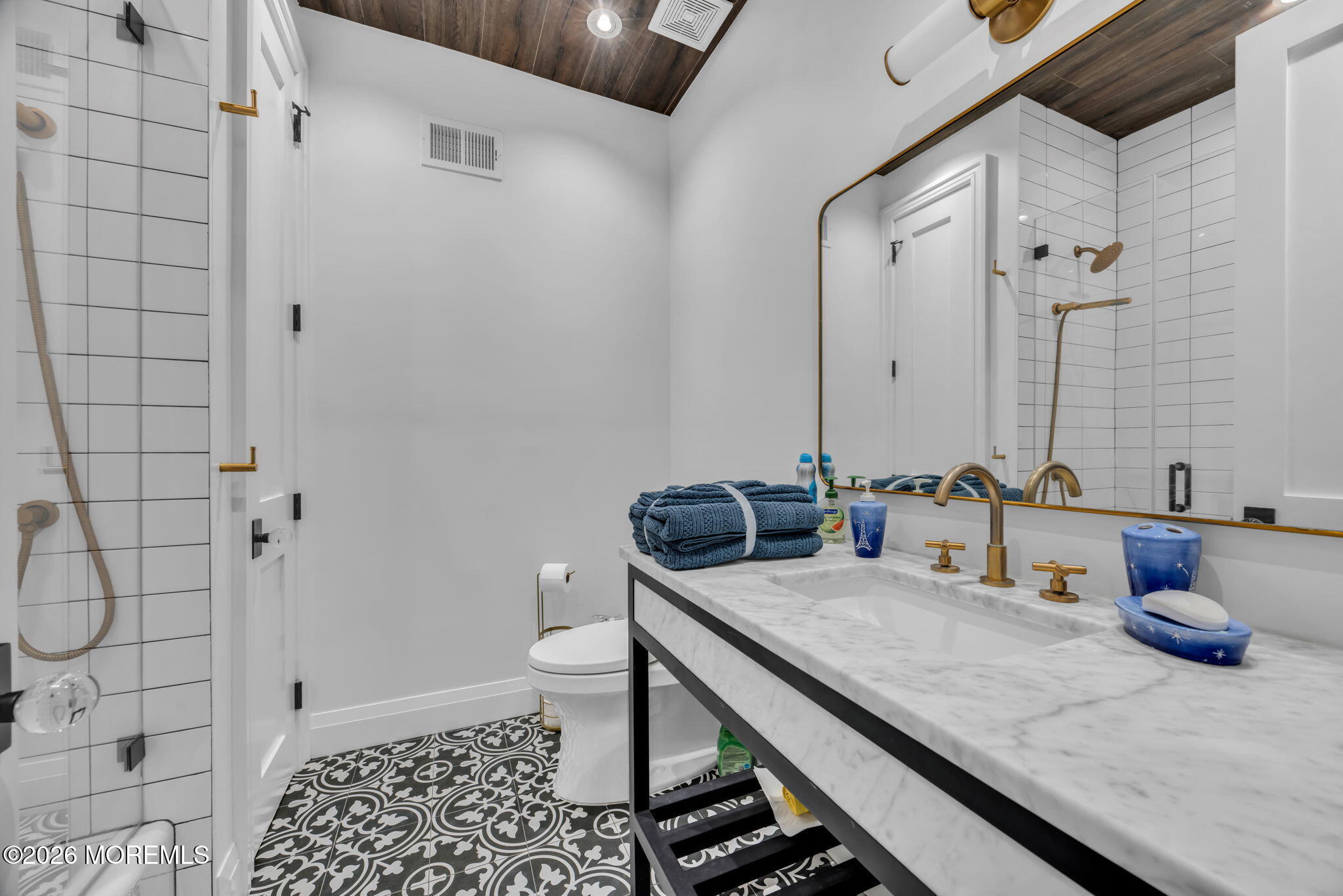 42 Marine Terrace Long Branch, NJ 07740 - Photo 22 of 36 a bathroom with a granite countertop sink a toilet and shower