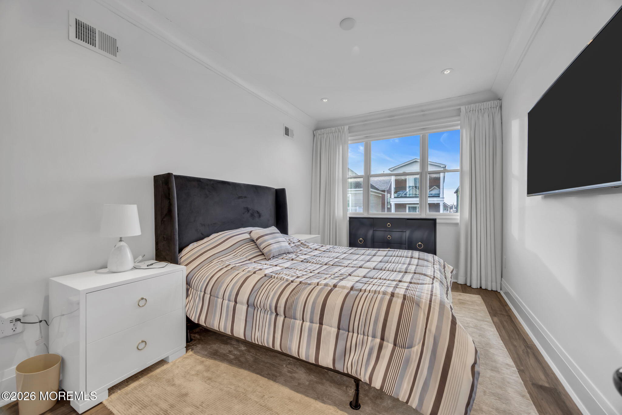 42 Marine Terrace Long Branch, NJ 07740 - Photo 26 of 36 a bedroom with a bed and a flat screen tv