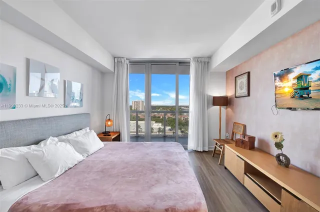 a bed room with a bed and a large window