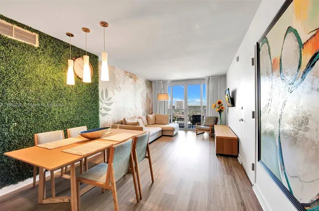 a view of a dining room with furniture window and wooden floor