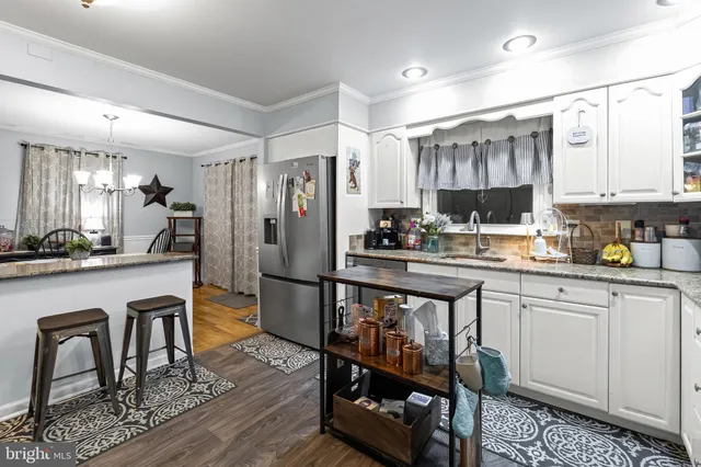 a kitchen with refrigerator and cabinets