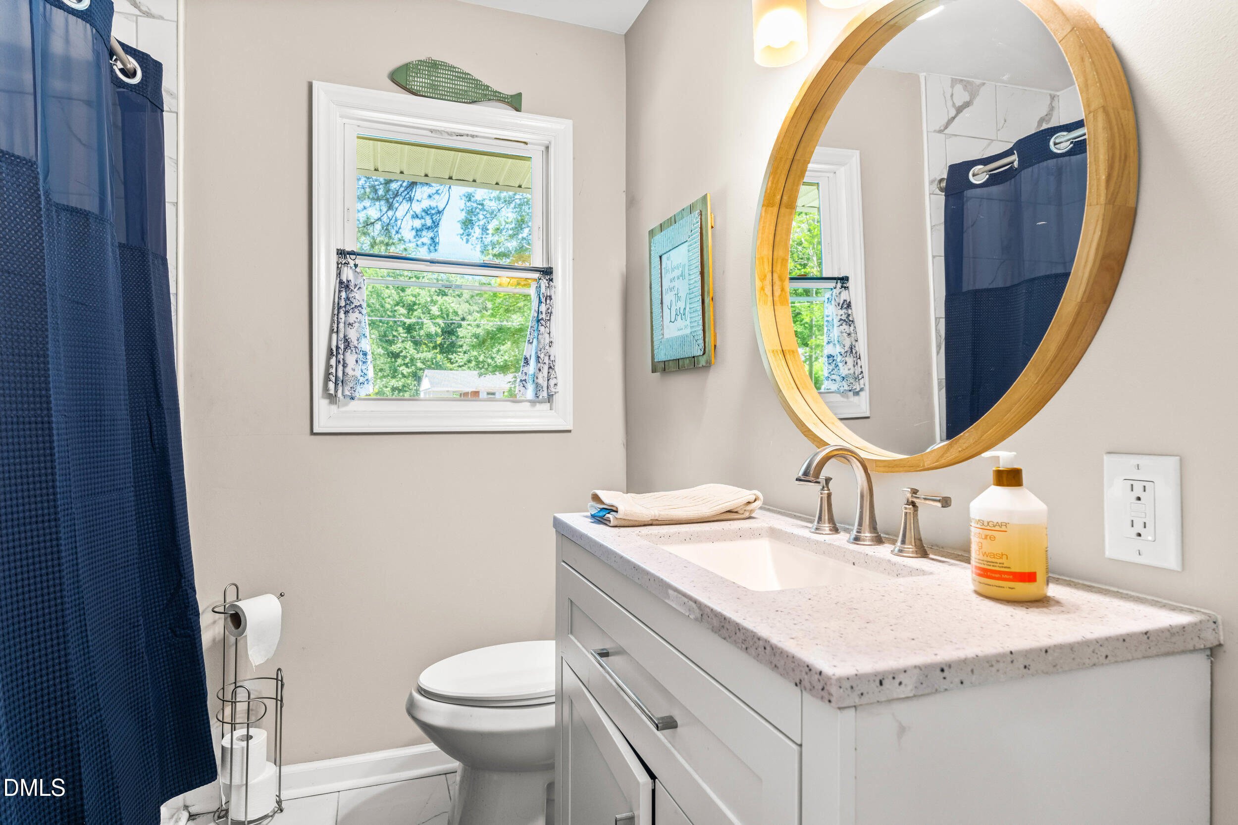 3724 Randell Road Garner, NC 27529 - Photo 24 of 32 a bathroom with a sink mirror vanity and toilet