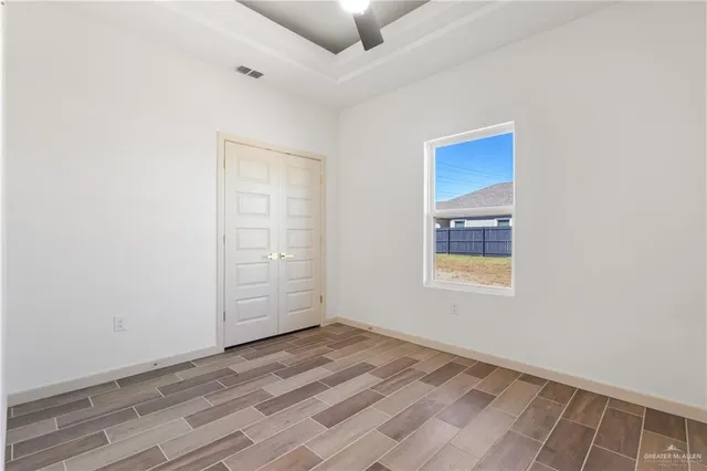 an empty room with windows and closet