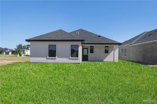 a front view of house with yard and green space