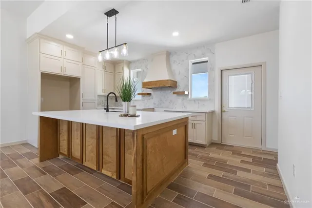 a large kitchen with kitchen island a sink stainless steel appliances and cabinets