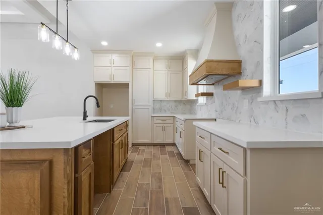 a kitchen with a sink stove and cabinets
