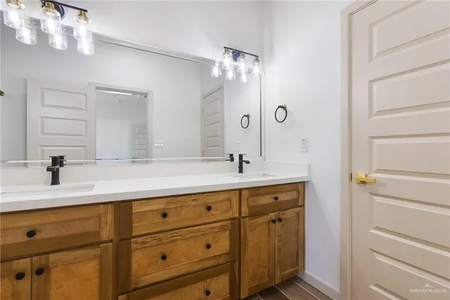 a bathroom with a sink vanity and mirror