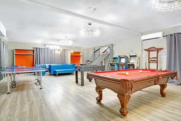 a view of a house with a big yard and large trees