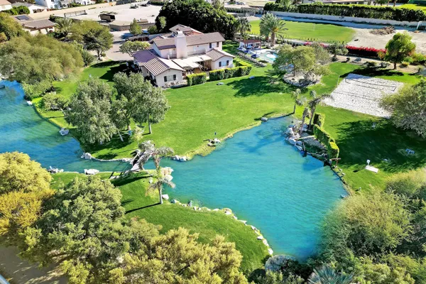 an aerial view of residential houses with outdoor space and trees all around