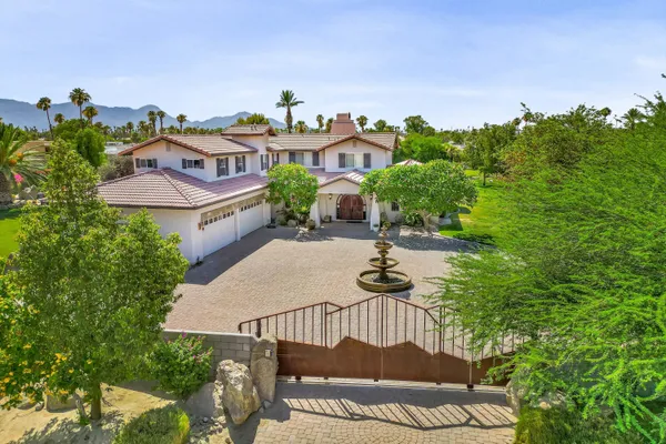 a view of a swimming pool with a patio and a garden