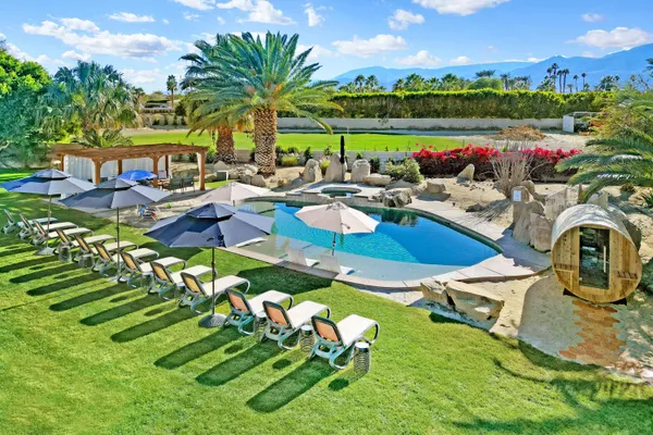 a living room with fireplace furniture and a painting