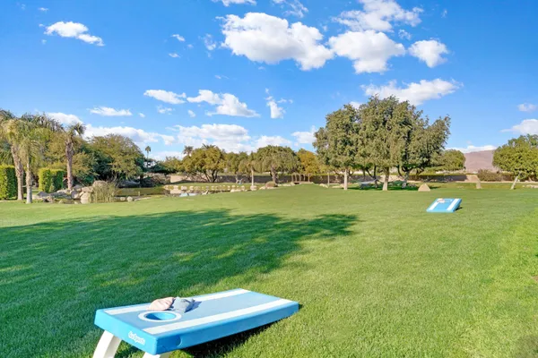 a living room with furniture a flat screen tv and a table