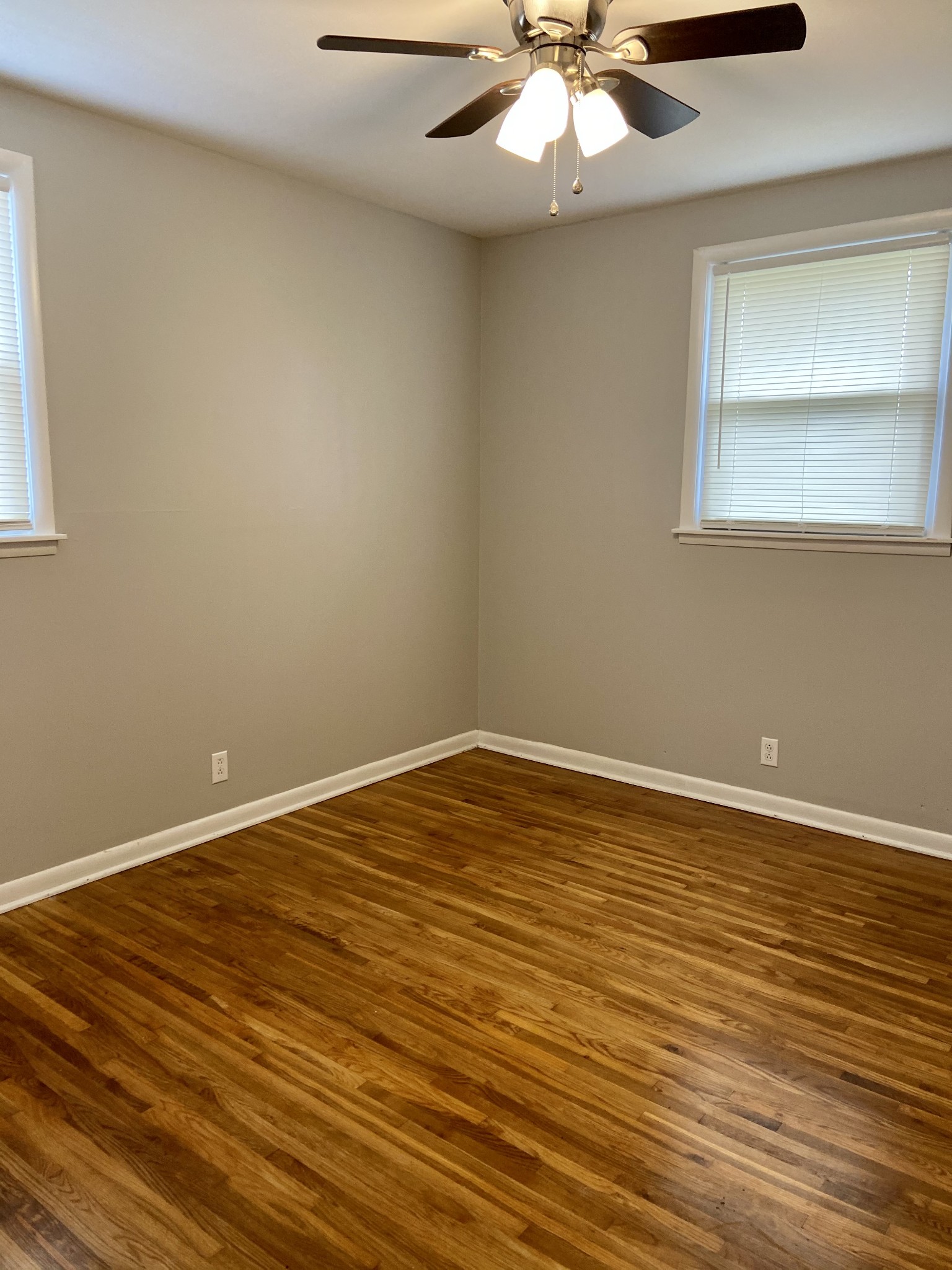 211 Pitt Lane Springfield, TN 37172 - Photo 13 of 18 a view of an empty room with wooden floor and a window