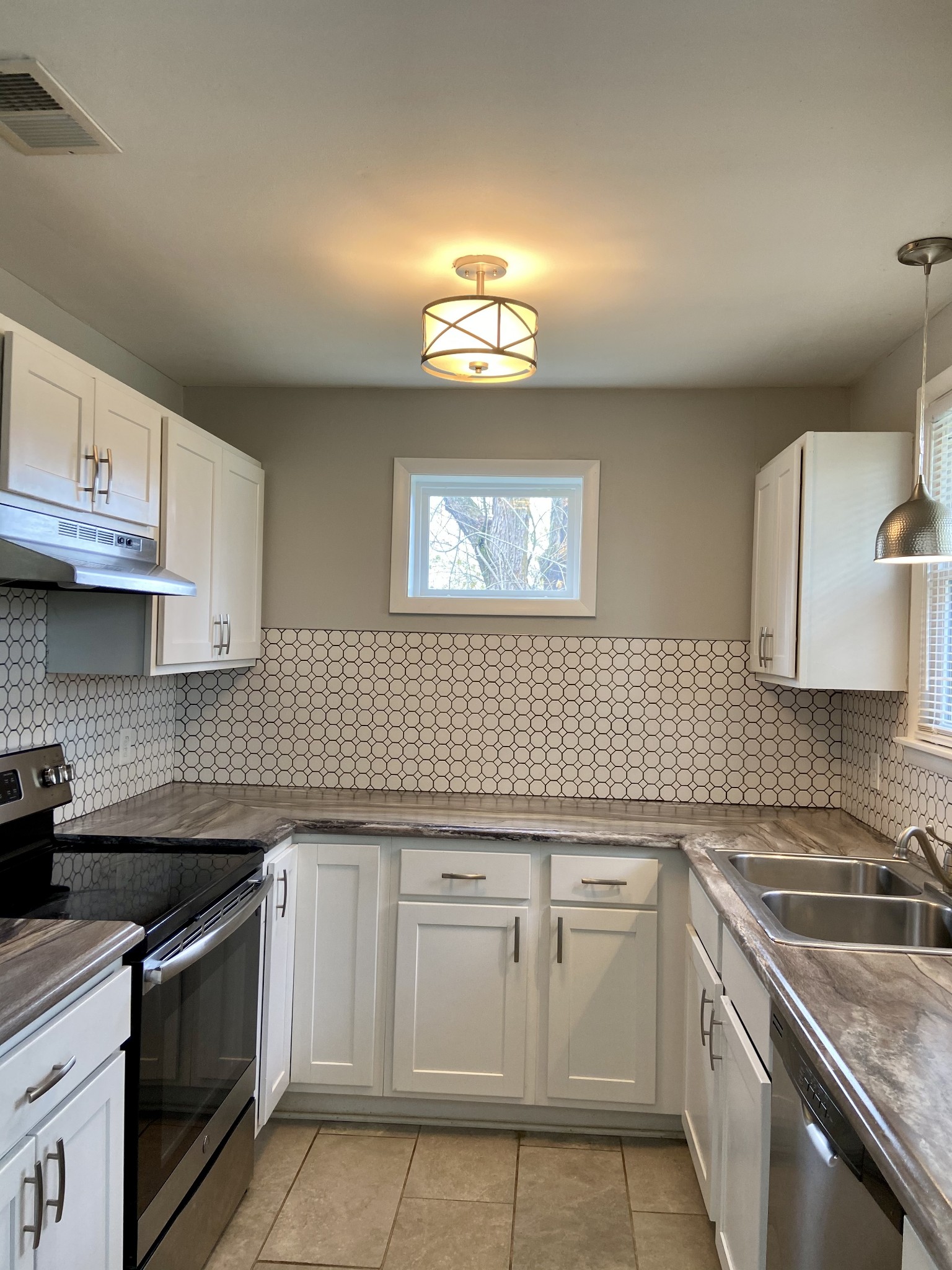 211 Pitt Lane Springfield, TN 37172 - Photo 7 of 18 a kitchen with cabinets appliances a sink and a counter top space