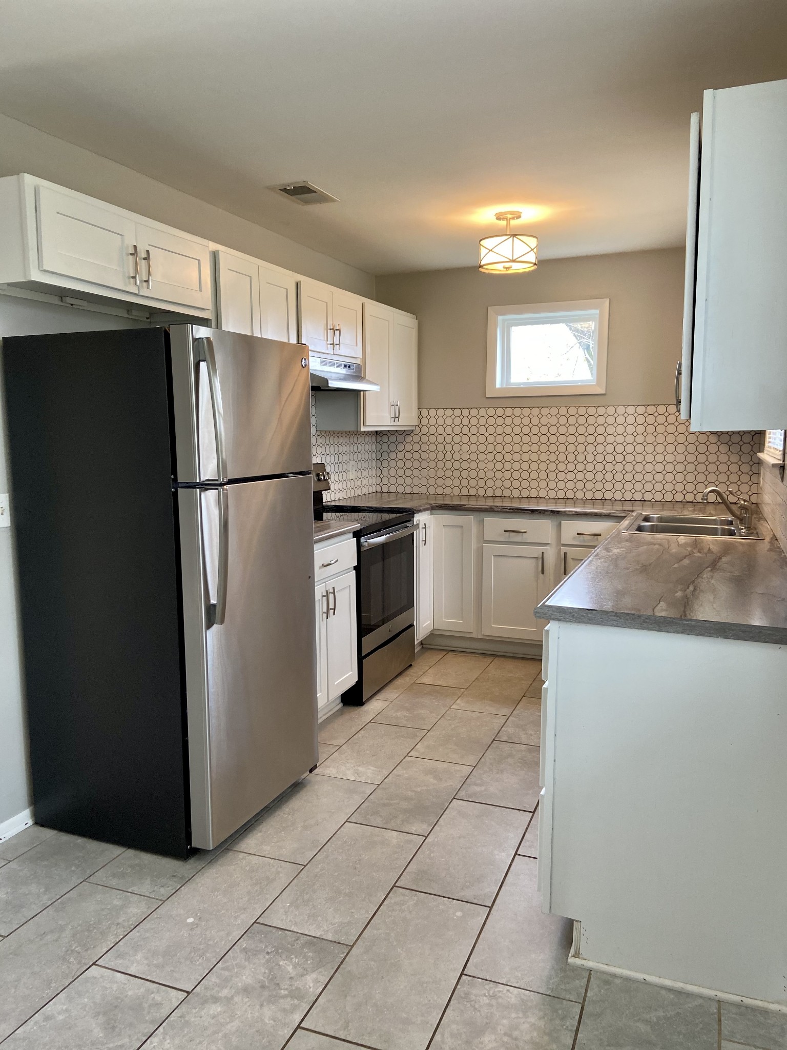 211 Pitt Lane Springfield, TN 37172 - Photo 8 of 18 a kitchen with granite countertop a refrigerator and a sink