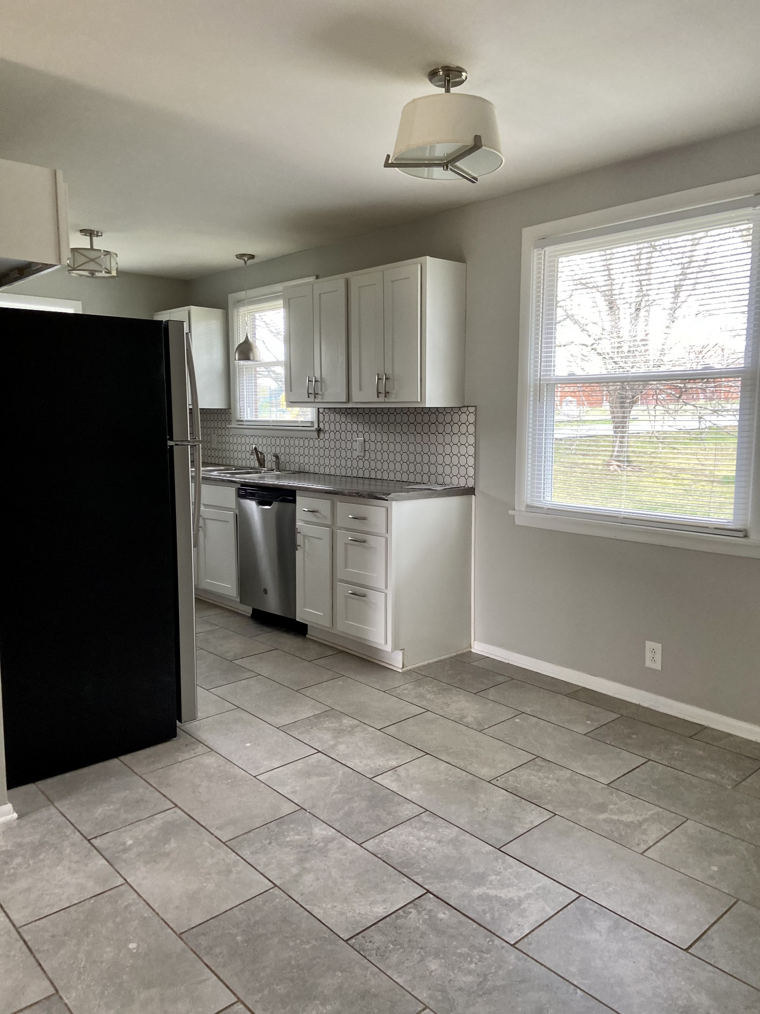 211 Pitt Lane Springfield, TN 37172 - Photo 9 of 18 a kitchen with stainless steel appliances granite countertop a sink and a stove