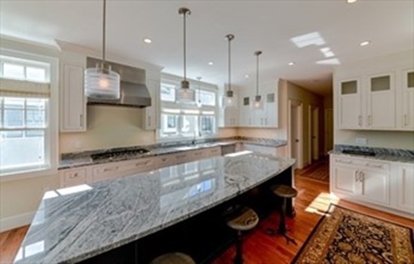 3 Mill Stone Drive, Unit 3 Sherborn, MA 01770 - Photo 10 of 23 a large kitchen with kitchen island a large island in it