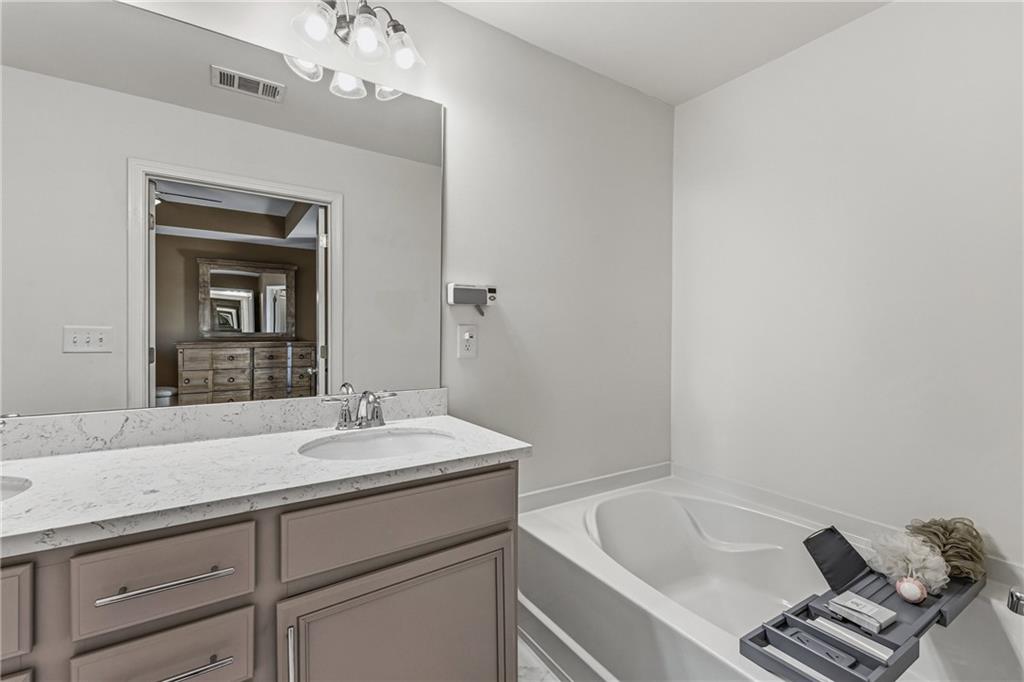 2275 Rolling Trail Lithonia, GA 30058 - Photo 18 of 38 a bathroom with a sink and a bathtub