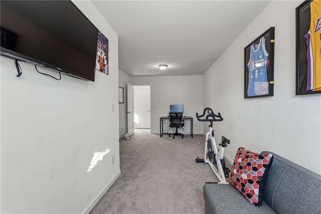 2275 Rolling Trail Lithonia, GA 30058 - Photo 22 of 38 a living room with furniture and a flat screen tv