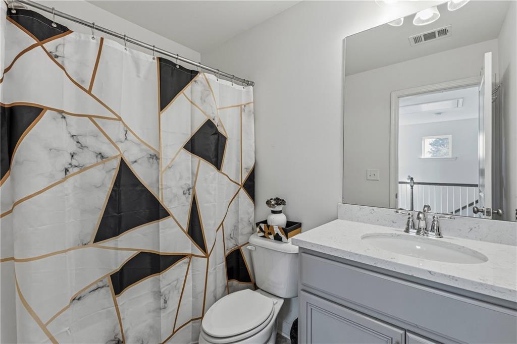 2275 Rolling Trail Lithonia, GA 30058 - Photo 26 of 38 a bathroom with a toilet a sink and a mirror