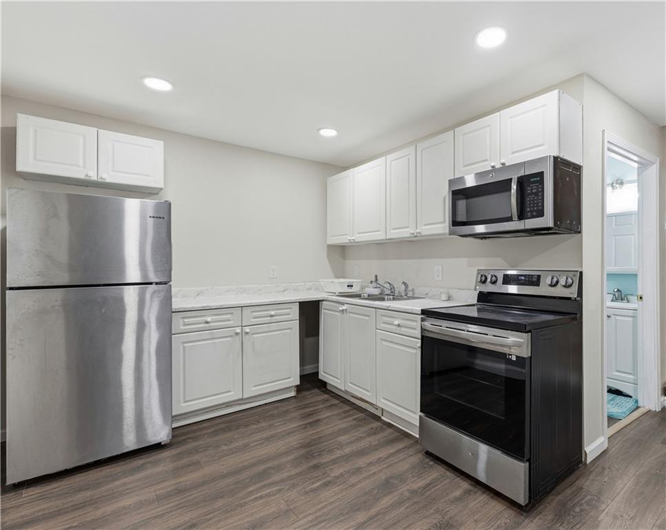 2275 Rolling Trail Lithonia, GA 30058 - Photo 29 of 38 a kitchen with granite countertop white cabinets and stainless steel appliances