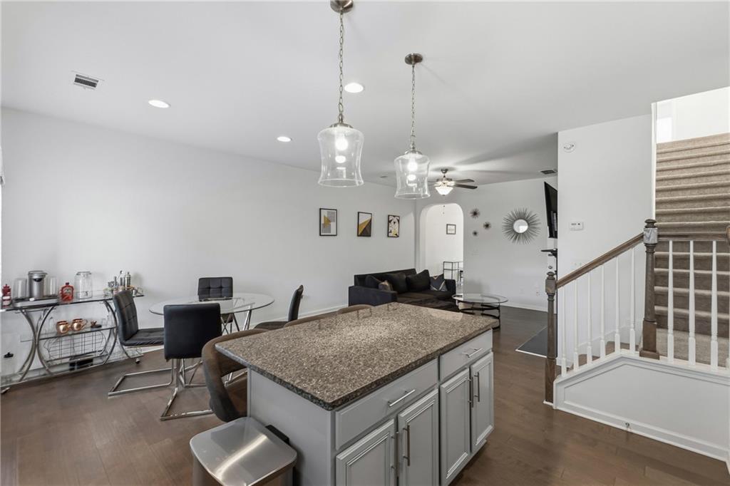 2275 Rolling Trail Lithonia, GA 30058 - Photo 8 of 38 a kitchen with stainless steel appliances granite countertop a stove a sink and a living room view