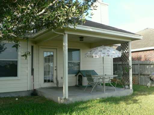 5105 Agen Drive Corpus Christi, TX 78413 - Photo 6 of 7 a view of a chair and tables in the back yard of the house
