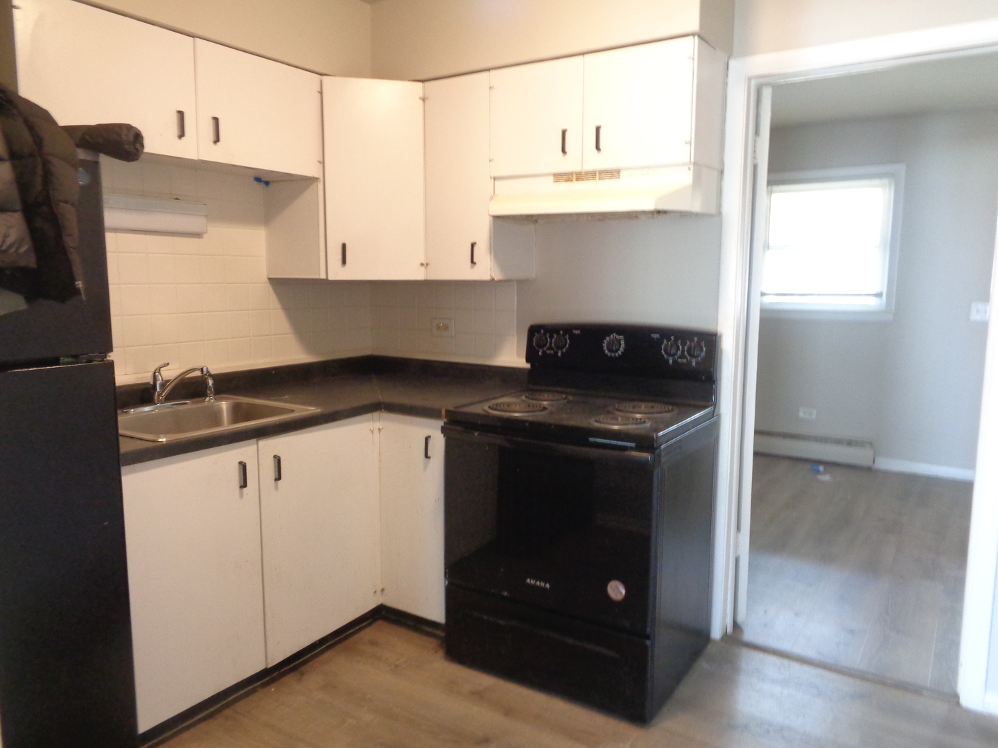 1340 North Main Street, Unit A13 Wheaton, IL 60187 - Photo 3 of 6 a kitchen with stainless steel appliances granite countertop a stove and a microwave