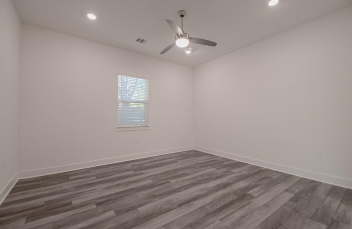6325 Ponca Street, Unit A Austin, TX 78741 - Photo 11 of 21 an empty room with wooden floor and windows