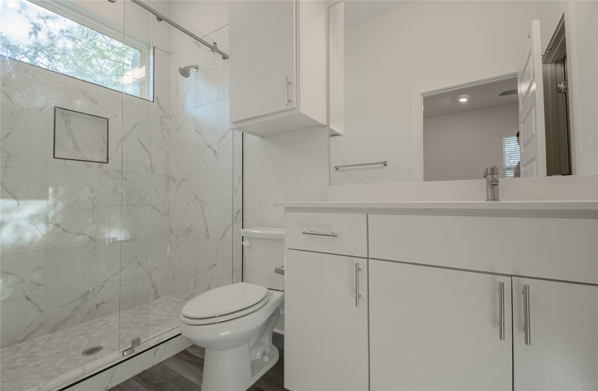 6325 Ponca Street, Unit A Austin, TX 78741 - Photo 12 of 21 a bathroom with a sink a toilet and shower