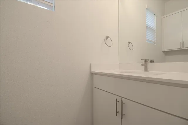 a bathroom with a sink and vanity