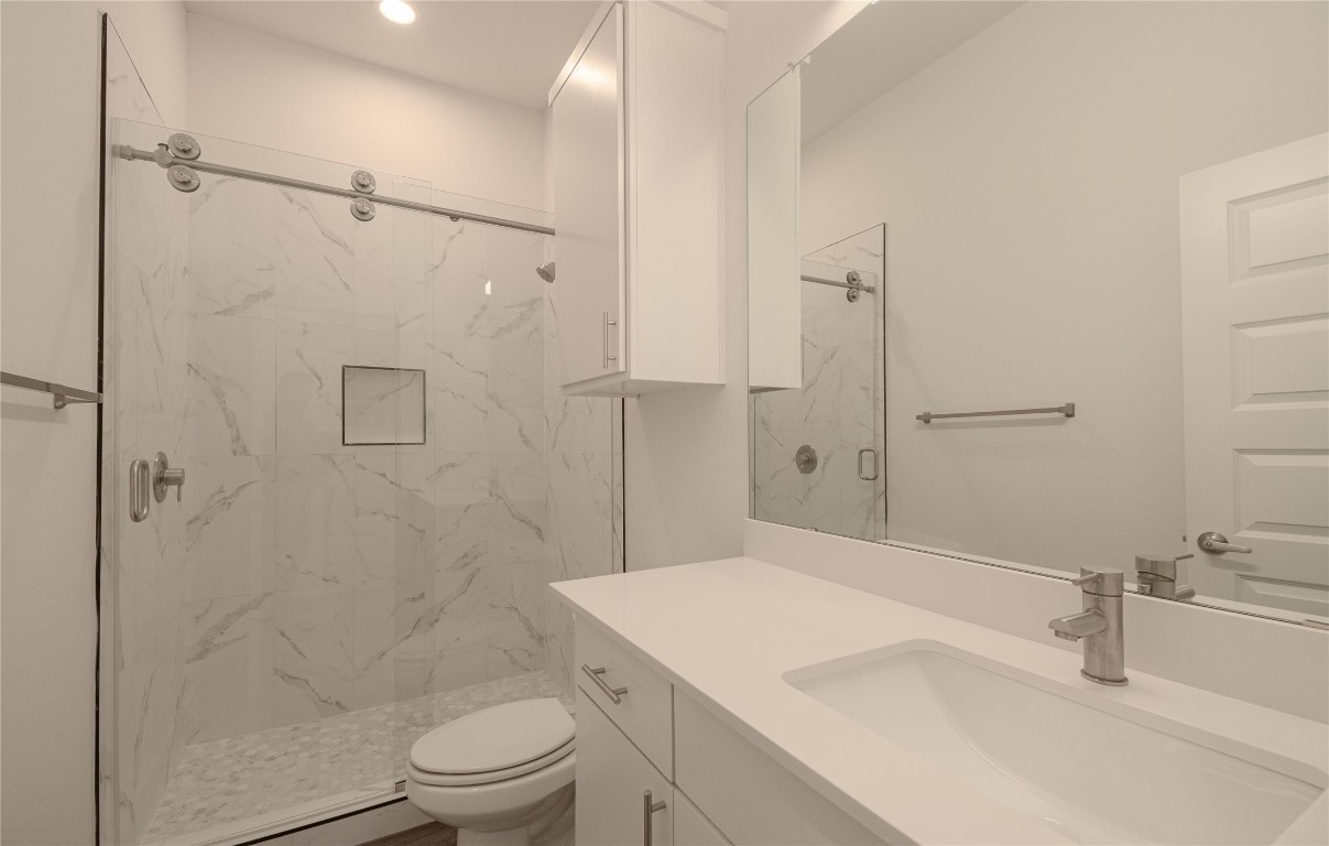 6325 Ponca Street, Unit A Austin, TX 78741 - Photo 18 of 21 a bathroom with a sink toilet and shower