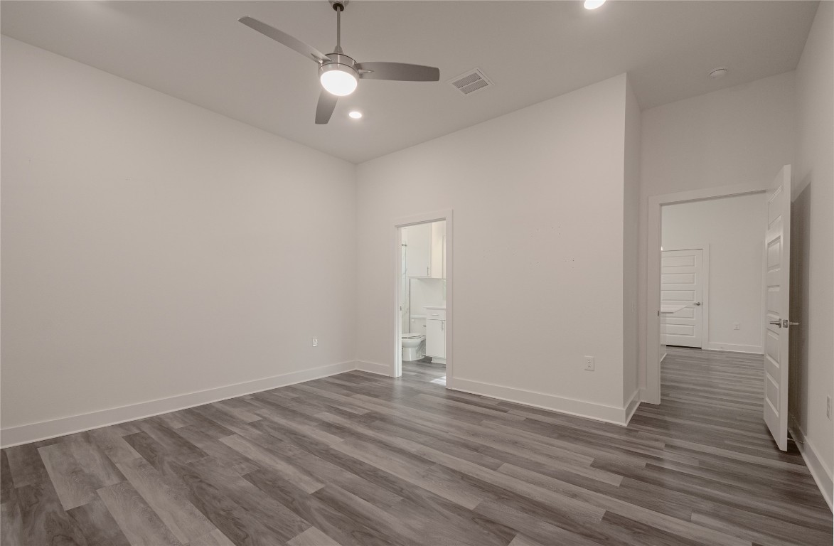 6325 Ponca Street, Unit A Austin, TX 78741 - Photo 10 of 21 an empty room with wooden floor and windows