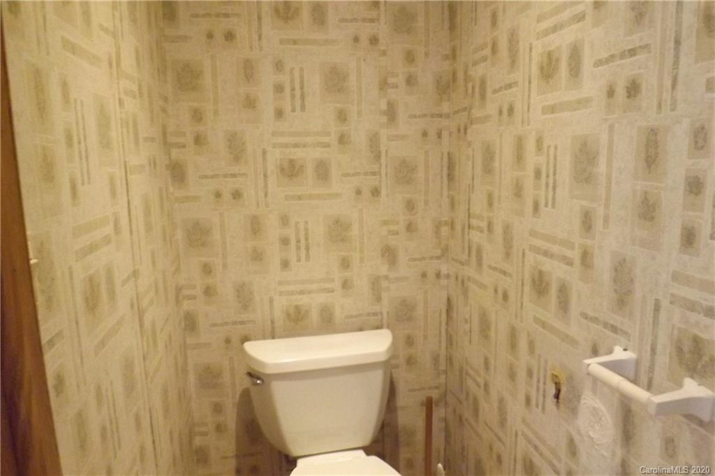 7080 Woodleaf Road Woodleaf, NC 27054 - Photo 14 of 21 a white toilet sitting next to a shower curtain