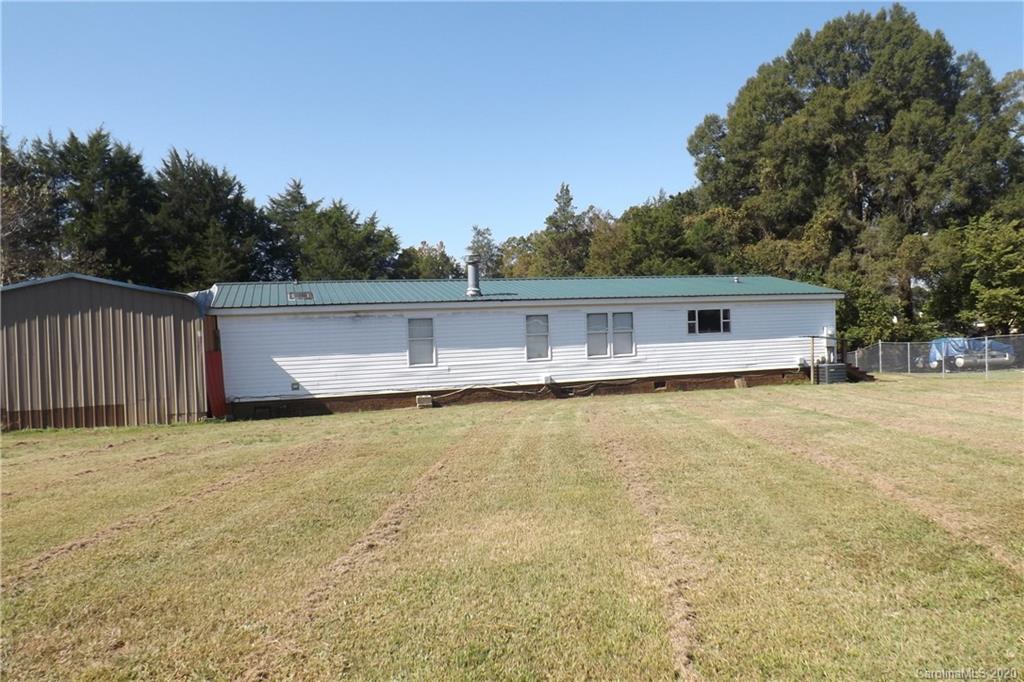7080 Woodleaf Road Woodleaf, NC 27054 - Photo 9 of 21 a front view of house with yard and trees in the background