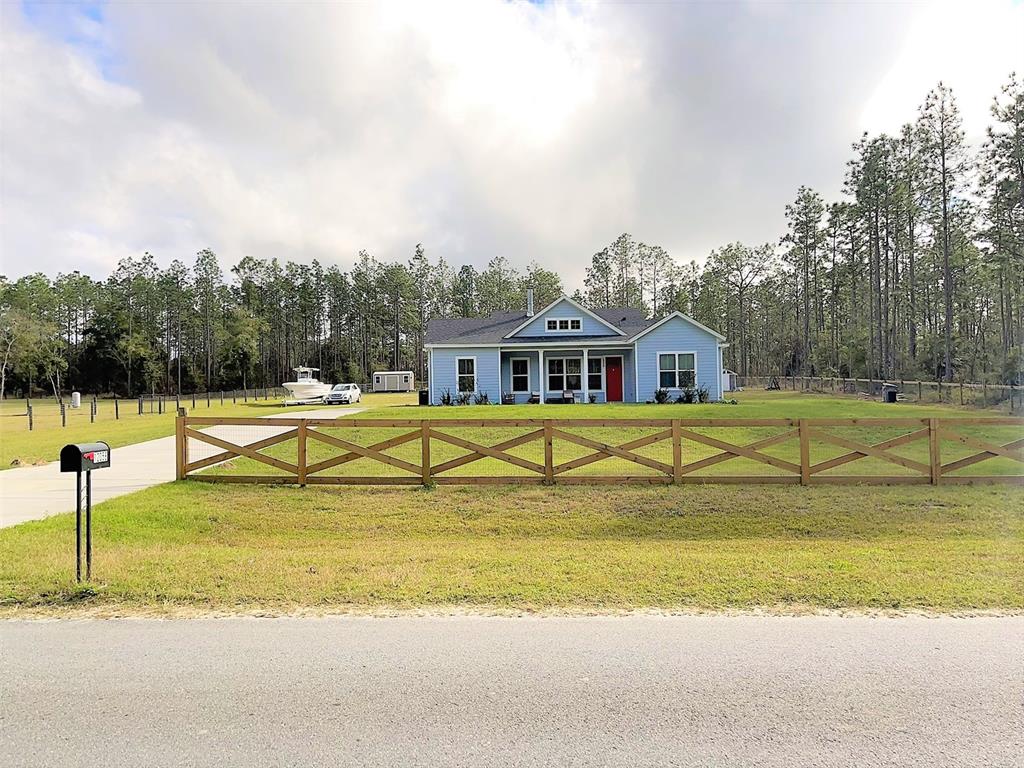 a view of a house with swimming pool and a yard