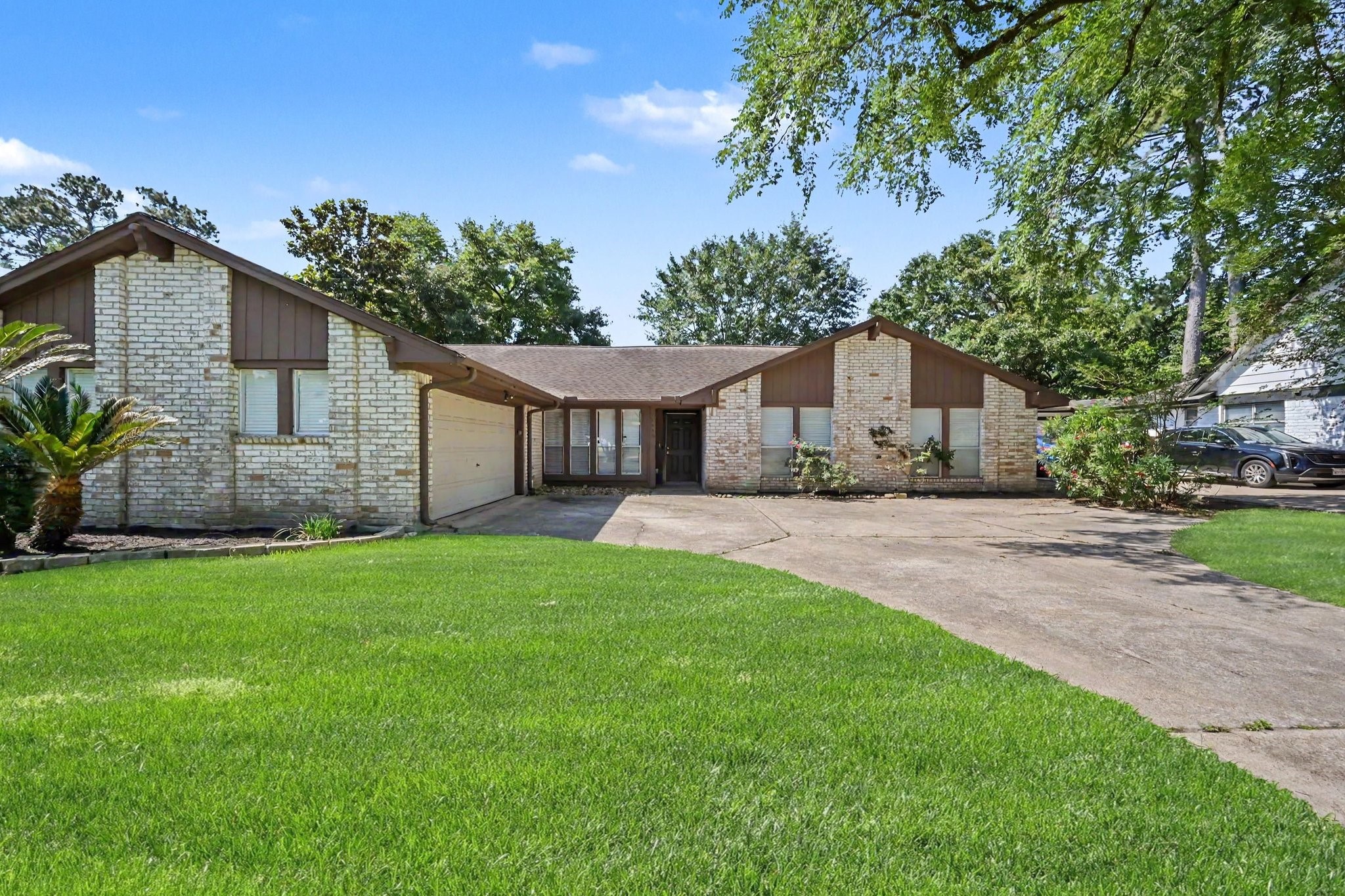 17419 Cassina Drive Spring, TX 77388 - Photo 1 of 35 a front view of a house with a garden and yard