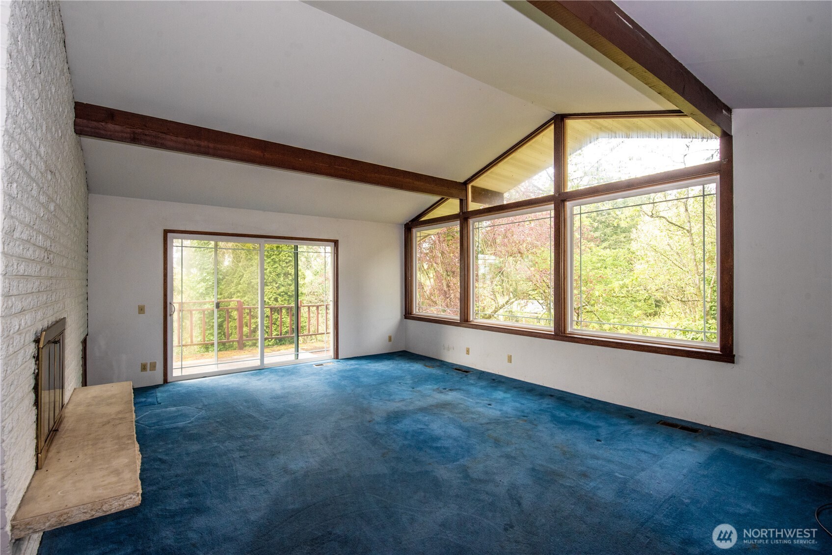 10015 Southeast 192nd Street Renton, WA 98055 - Photo 5 of 39 a view of an empty room with a fireplace and a window
