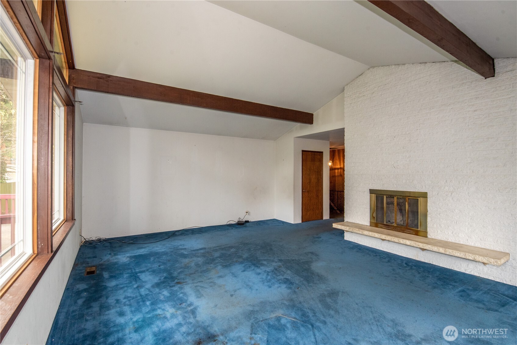 10015 Southeast 192nd Street Renton, WA 98055 - Photo 7 of 39 a view of an empty room with a window and fireplace