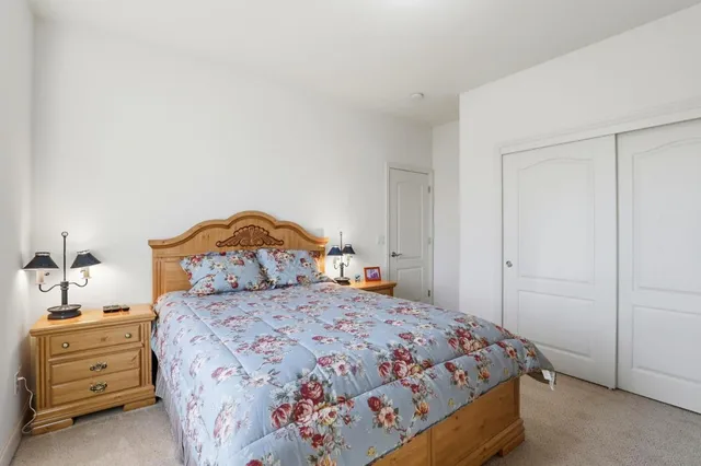 a bedroom with a bed and a dresser in it