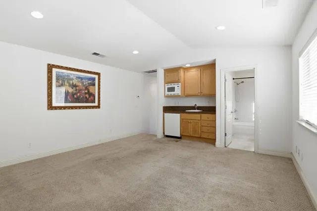 an empty room with a cabinet and a stove top oven