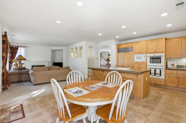 a dining room with furniture a large window and a chandelier