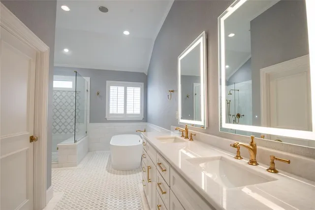 a spacious bathroom with a double vanity sink a toilet and a shower